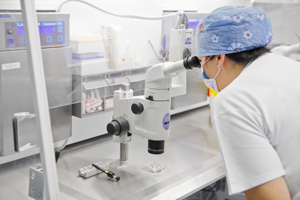 An employee at Unica Clinic in the Czech Republic using a microscope in the IVF laboratory