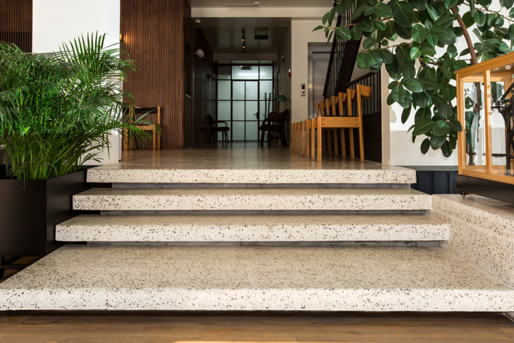 Modern and welcoming entrance to the ReproART clinic, featuring plants and wooden accents that create a warm atmosphere for patients at the IVF treatment center.