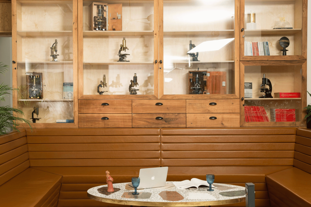 Exhibition of historical microscopes in the ReproART clinic waiting area, symbolizing the connection between tradition and modern medical technology in reproductive health.