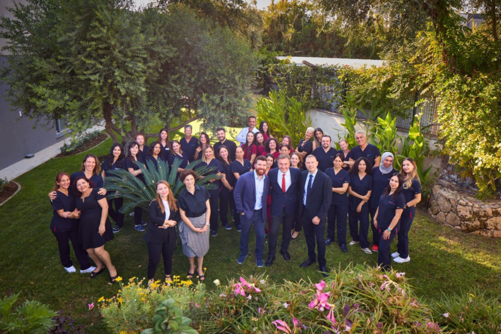 Experienced doctors and staff of Dünya IVF Clinic gathered in front of the fertility center