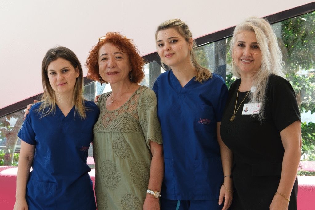 Four staff members of the British Cyprus IVF clinic standing together, representing the professional team in in vitro fertilization.