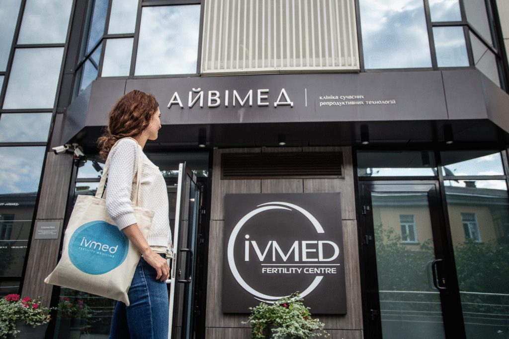 A female patient standing outside and looking at the building of IVMED Fertility Clinic Ukraine.